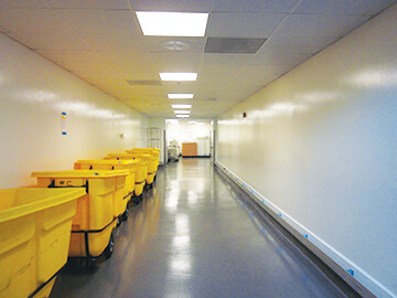 Empty carts along hallway in a vivarium facility | Hapman.com