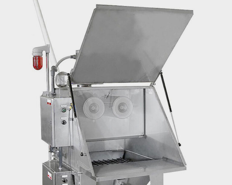 Industrial stainless steel blast cabinet with an open lid, showing internal circular components and a bottom grate.