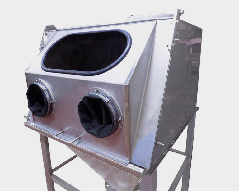 Stainless steel industrial glove box with a viewing window and two glove ports, mounted on a metal stand.