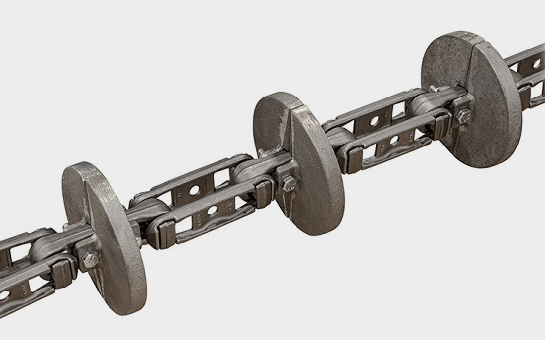 A metal drag conveyor chain with regularly spaced circular flights.