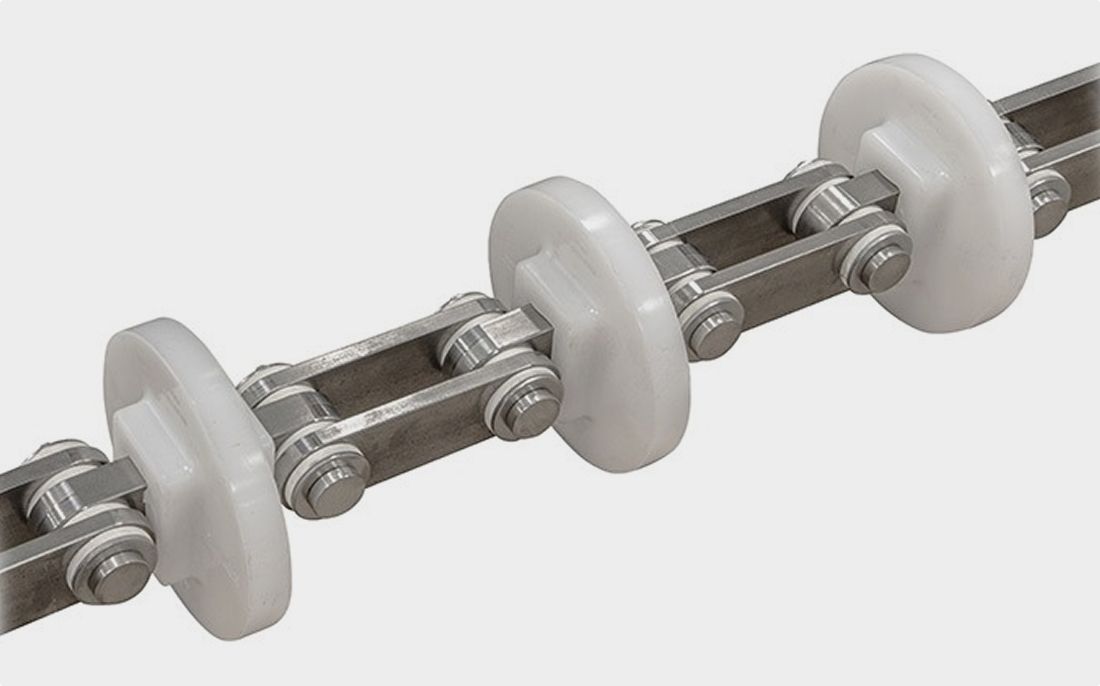 A metal roller chain featuring evenly spaced white circular plastic guides.